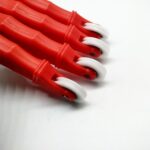 Close-up of concave grooved nylon guide wheels on TradeBase flyscreen spline roller tools