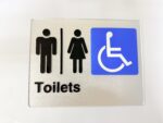 Silver Braille toilet sign with Male, Female and Accessible pictograms, 235 x 180mm