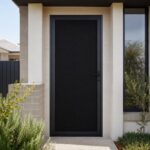 Black DVA privacy mesh fitted to a security screen door viewed from outside, appearing dark and hiding the interior