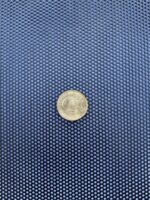 Black perforated aluminium security mesh with an Australian dollar coin on it for scale, showing 2mm round holes on 5mm staggered pitch