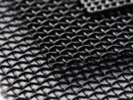 Macro close-up of black 316 stainless steel woven security mesh showing 0.8mm wires crossing over and under with 1.55mm square apertures